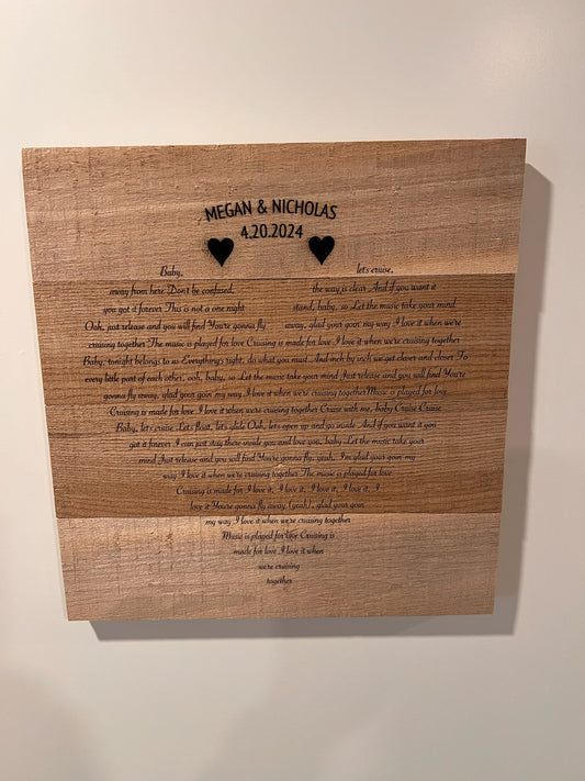 Engraved song lyrics on pallet wood.